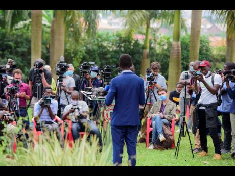 The National Unity platform presidential candidate Bobi Wine addresses the media at his home in Magere, Uganda, last Friday. Wine, a popular singer-turned-lawmaker half the president’s age, alleges that the vote in the East African country was rigged. 