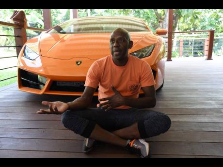 Seated in front of his Lamborghini, Hugh Graham admits that he has an addiction for luxury vehicles.
