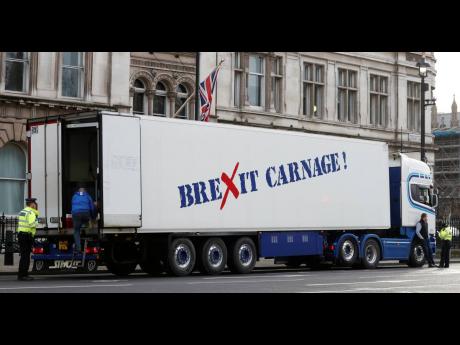 A policeman escorts the driver of a shellfish export truck as he is stopped for an unnecessary journey in London on Monday, January 18, during a demonstration by British shellfish exporters to protest Brexit-related red tape they claim is suffocating their