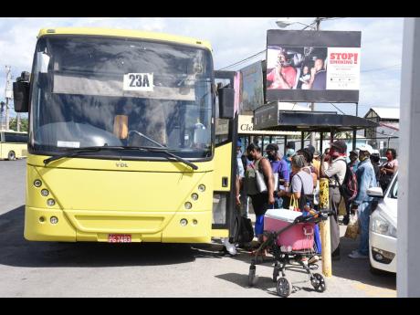 Passengers board a Jamaica Urban Transit Company bus in Spanish Town, St Catherine.
