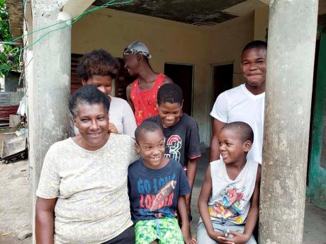 Edwinna Nelson-Thomas and some of the children welcome at her home in Logwood, St Thomas.