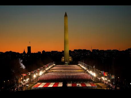A field of flags is spread across the National Mall, with the Washington Monument in the background, on Tuesday, as seen from the West Front of the United States Capitol on the eve of the 59th presidential Inauguration in Washington. Joseph R. Biden will t