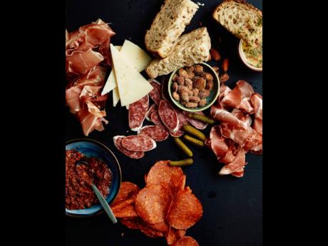 LEFT: It wouldn’t be a tapas bar without a charcuterie, cold cuts (chorizo sausage, coppa di Parma, serrano ham), smoked almond, manchego cheese, bread and a homemade spread mixture (olives, sundried tomatoes,  garlic, thyme, pimento, onions).