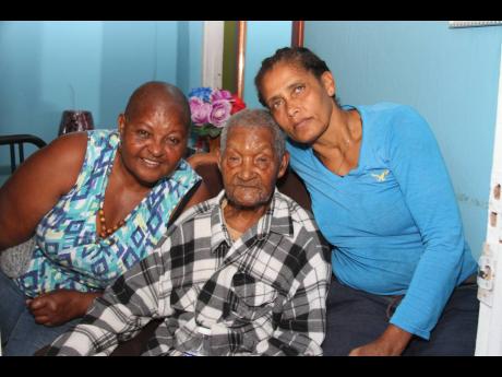 Stephen Wright shares a light moment with niece Marcia Carnegie-Ramsamugh and his caregiver and granddaughter, Waldene Levy. 