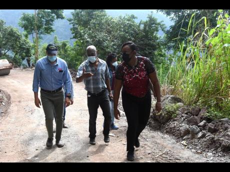 National Works Agency CEO E.G. Hunter (centre) touring the Gordon Town and Savage Pen roads alongside Prime Minister Andrew Holness and St Andrew East Rural Member of Parliament Juliet Holness on December 5. The Government allocated Christmas funding to re