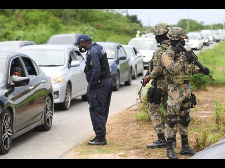 
Members of the security forces carrying out an operation along the Hellshire main road last October, taking into custody a number of persons who could not produce identification or give a suitable reason for being in the area. Earlier in the day, they had