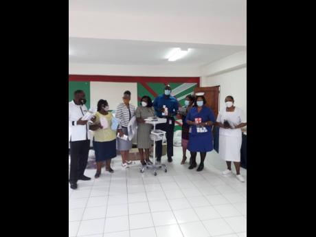 The presentation of the ECG machine to the Spanish Town Hospital.