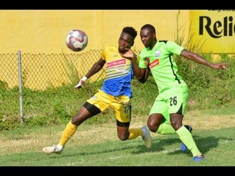 Damion Thomas (right) of Harbour View FC battles with Romario Campbell of Molynes United in their Jamaica Premier League match at the Constant Spring Sports Complex on Thursday, November 27, 2019.