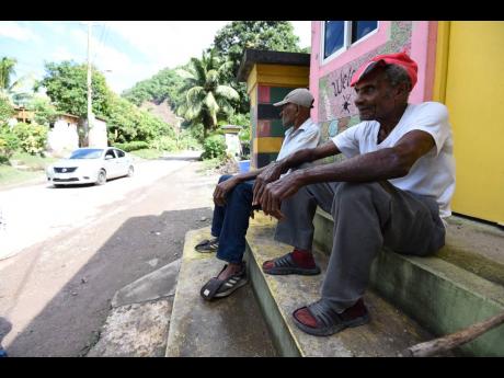 Herman Latouche (foreground) and Herman Walters of Broadgate, St Mary, lament the slow pace of the road rehabilitation.