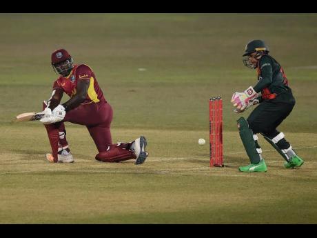 West Indies batsman Rovman Powell (left) plays a sweep shot during his innings of 47 against hosts Bangladesh in their third One-Day International in Chattogram, yesterday.