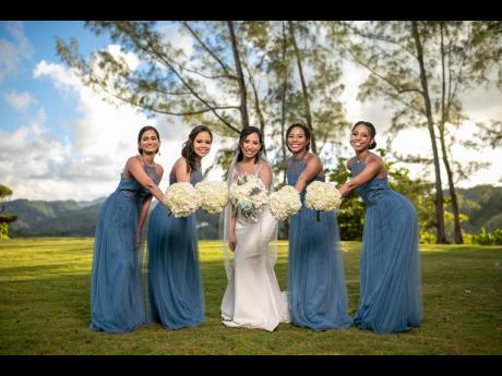 Melissa Robinson (centre) is joined on her special day by her supportive bridesmaids. From left: Trusha Goffe, Shari Dacosta, Rachel Robinson and Alicia Robinson.
