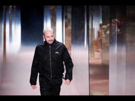 Designer Kim Jones accepts applause at the end of the Fendi Spring-Summer 2021 Haute Couture fashion collection presented on Wednesday.
