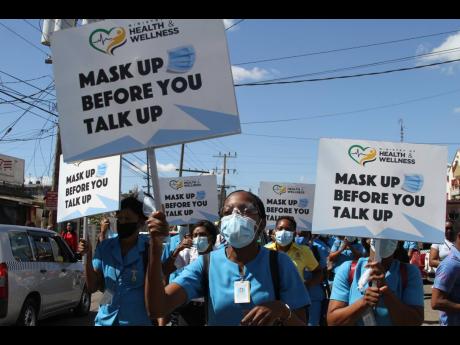 Nurses marching in Mandeville, Manchester, as part of the COVID-19 'Mask Up Before You Talk Up' campaign led by Minister of Health and Wellness Dr Christopher Tufton on Wednesday. See related story on A3.

 