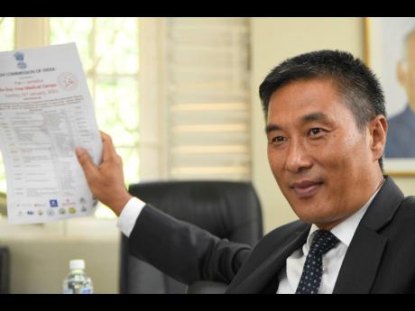 Indian High Commissioner to Jamaica, Runsung Masakui, holds up a document while speaking of plans to strengthen trade and investment ties bewteen India and Jamaica, during an interview on January 25.
