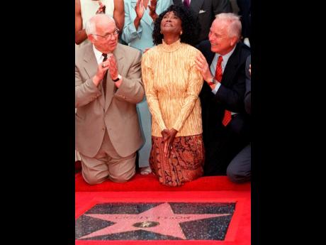 
Academy Award-nominated actress Cicely Tyson (centre), reacts to the unveiling of her star on the Hollywood Walk of Fame in the Hollywood section of Los Angeles, August 21, 1997. Honorary mayor of Hollywood and chairman of the Walk of Fame committee, John