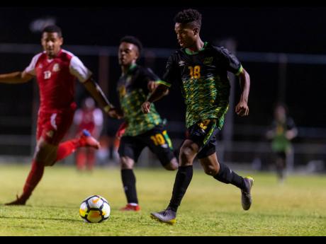 Jamaica’s Lamar Walker (right) in action ahead of teammate Alex Marshall (centre) and opponent Ezrick Nicholls of St Kitts and Nevis in an Olympic qualifier, played at the Anthony Spaulding Sports Complex on Sunday, July 21, 2019.