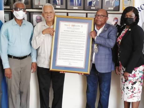 Vocational award: Alister Cooke (second left), former general manager of the Shipping Association of Jamaica and Kingston Wharves Limited, accepts a citation for vocational service from Alva Wood (second right), president of the Rotary Club of Kingston. Al