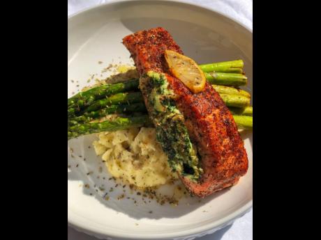 Pan-seared salmon, stuffed with spinach and mozzarella and cream cheese, on a bed of buttery asparagus and creamy garlic mashed potatoes. 
