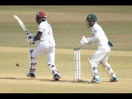 Windies batsman Jermaine Blackwood (left) plays a stroke during the third day of their first Test match against hosts Bangladesh in Chattogram on Friday.