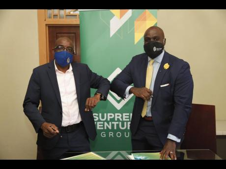 McKayla Financial Managing Director Delroy Josephs (left) and Damian Duncan of Supreme Ventures seal their deal – SVL’s 51 per cent acquisition of McKayla – with an elbow bump on Friday, February 5, 2021.