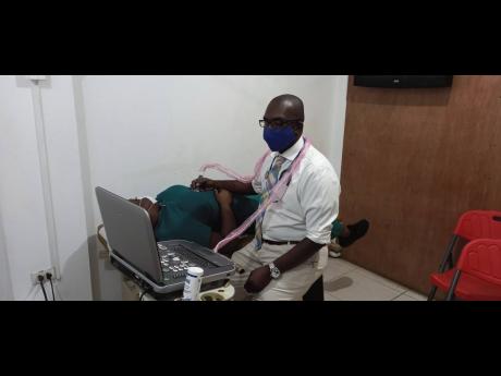 Dr Hugh Ellis performing an ultrasound.