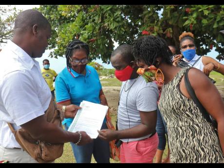 Union delegate Damion Clarke (left) speaks with (from second left) Ruth Reid, Jermaine Hall and Stacyan Hutchinson, employees of El Greco Resort