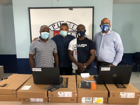 From left: Class of 85 Jamaica College (JC) Old Boys Dexter Williams, Sean Smith, Paul Lettman and Stephen Dunkley pictured with the technological devices donated to JC students.