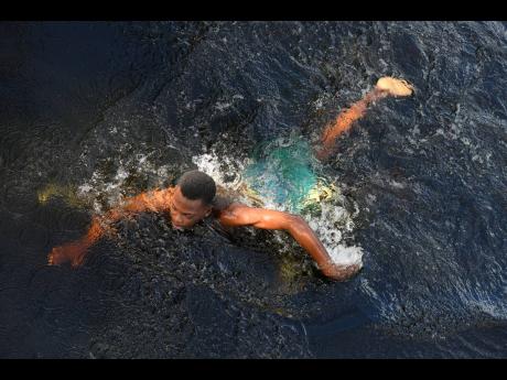 Arief Samms takes a swim in the Black River, adjacent to his fathers establishment in the Vineyard district, St Elizabeth.