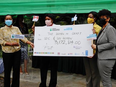 From left: Marsha Smith, state minister, in the Ministry of Finance and Public Service; Maxine Smith-White, of Dunn’s River Falls and Park; Shyrell Lewis, TPDCo, and Heather Pinnock, general manager, UDC with the symbolic cheque. 
