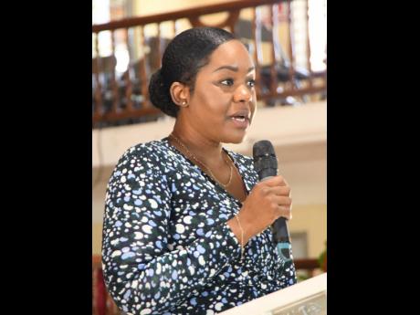 Tamera Harrison, the niece of Yvonne Sterling, reads the eulogy at the thanksgiving service for the late reggae songbird, held at the Portmore Seventh-day Adventist Church on Sunday.
