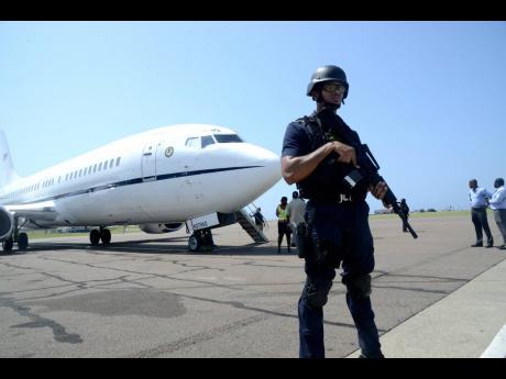 A policeman is seen monitoring an extradition exercise at the Norman Manley International Airport in this April 2017 photograph. A Jamaican man was extradited to the United States in January 2021 after more than 20 years on the run. 