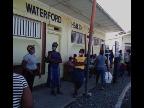 Patients waiting outside the Waterford Health Centre. Residents contend that the facility needs to be expanded and improved to serve an increasing number of patients.