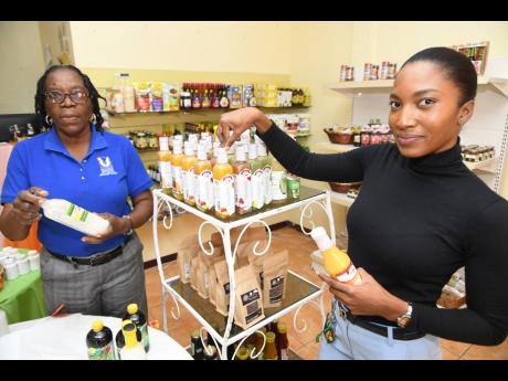 Karen Demns (left), clerk at Agri-mart; and Shauna Parkinson, social service/home economics officer, Agri-mart, display some of the products available at the Old Hope Road facility.