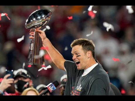 Tampa Bay Buccaneers quarterback Tom Brady celebrates with the Vince Lombardi Trophy after the NFL Super Bowl 55 football game against the Kansas City Chiefs Sunday, February 7, 2021, in Tampa, Florida. 
