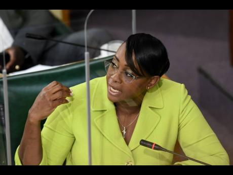 Juliet Holness gestures while making a point during a meeting of the Public Accounts Committee of Parliament on Tuesday.
