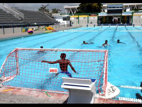 Members of the Jamaican water polo team take part in a practice session at the National Aquatic Centre, which is located in the Independence Park Complex.