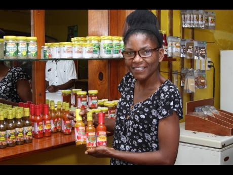 Julian Gordon, managing director of Lincoln Gordon & Sons, in Summerfield, Clarendon, shows off the signature product – hot pepper sauce.