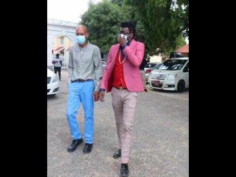 Dancehall artiste Moses ‘Beenie Man’ Davis (right) and his attorney, Roderick Gordon, outside the St Elizabeth Parish Court in Black River yesterday.