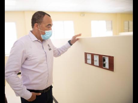 Minister of Health and Wellness Dr Christopher Tufton examines fixtures at the recently constructed COVID-19 field hospital located at St Joseph's Hospital in Kingston on February 11.