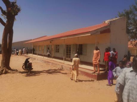 People gather inside the Government Science Secondary School in Kankara, Nigeria, last year December. Nigerian police say that hundreds of students are missing after gunmen attacked the secondary school in the country’s northwestern Katsina state. 
