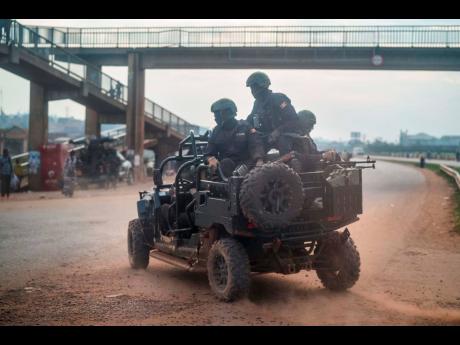 
In this January 14, 2021 file photo, security forces patrol the streets on election day in Kampala, Uganda. Residents haven’t been able to use Facebook, Twitter and other social media since an election three weeks ago. Around the world, shutting down th