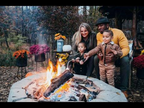 Darian Bryan and wife Jessica roast marshmallows with son Darian Jr and daughter Nina.