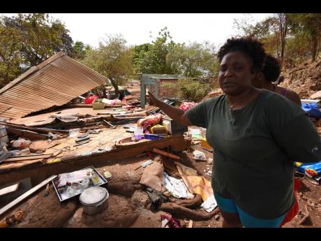 Crystal Walker shows the trail of destruction after her home and several others on Innswood lands in St Catherine were demolished on Saturday.
