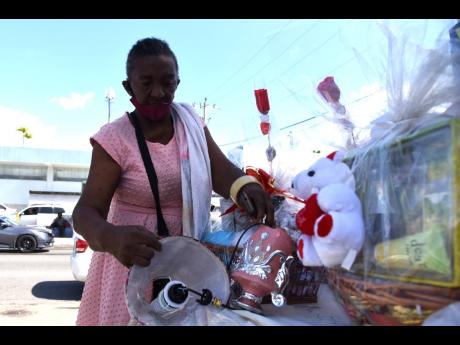Kay Williams, a vendor in the Constant Spring Arcade, takes to the roadside to catch Valentine’s sales amid a slump in business.