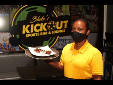 Doriann Smith serves up some scrumptious BBQ wings at Blake’s Kickout Sports Bar and Lounge.