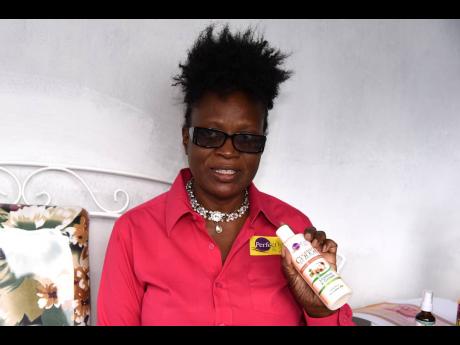 Owner and operator of Perfect Hair and Skin, Denese Hamilton, shows off her line of skin and hair care product.