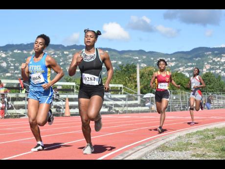 Shianne DaCosta (left) of Hydel High School wins the Class One Girls 800m at the Tyser Mills Track Meet at the Calabar High School on Saturday, December 12, 2020. This was the only junior track and field meet to take place locally since the start of the pa