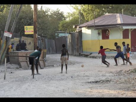 Children enjoying a game of football on one of New Haven’s unpaved streets on January 28, 2021.