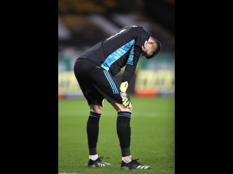 Leeds United’s goalkeeper Illan Meslier stands on the pitch in dejection after being at fault for the game’s only goal during the English Premier League match against Wolverhampton Wanderers at the Molineux Stadium in Wolverhampton, England yesterday.