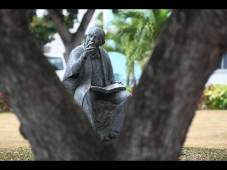 A statue of Sir Philip Sherlock at the Mona Campus of The University of the West Indies. University leaders have called for their staff and students to be among the second-string cohort to receive the coronavirus vaccine.